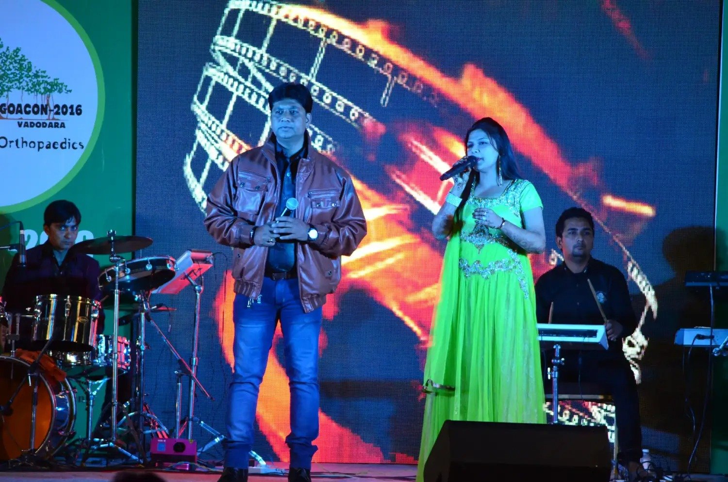 ITT event entrance with red and green carpet and pink lighting on white structure with ITT branding