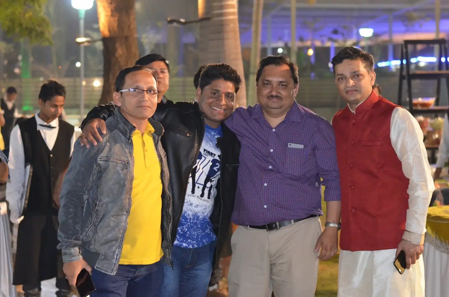 Musical performance on stage with three performers and ITT banner in background