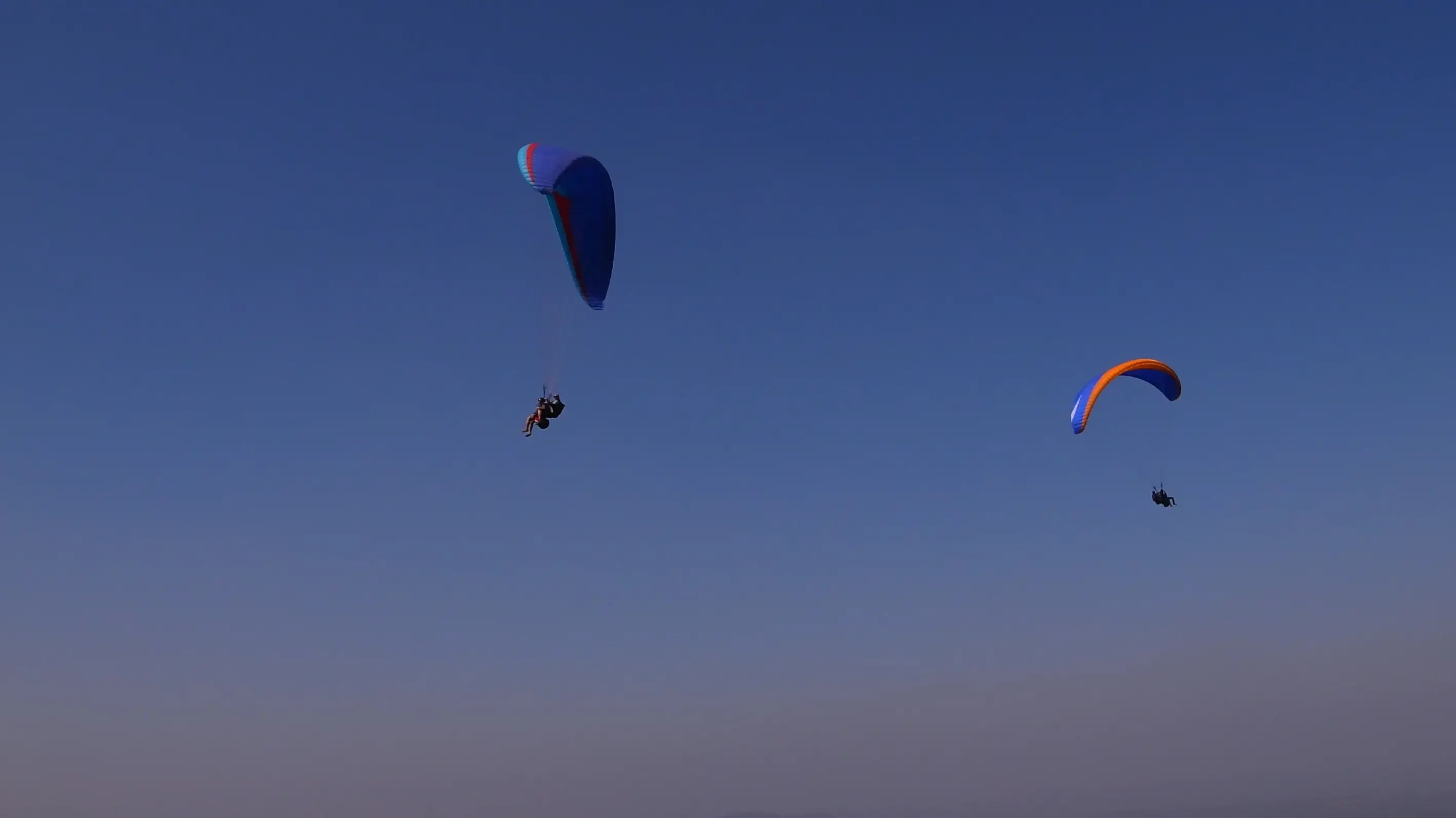 Men lighting ceremonial lamp at event with ITT banner in background