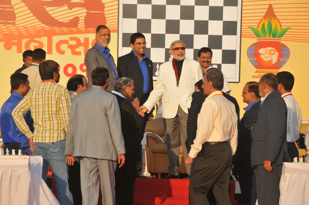 Men lighting ceremonial lamp at event with ITT banner in background