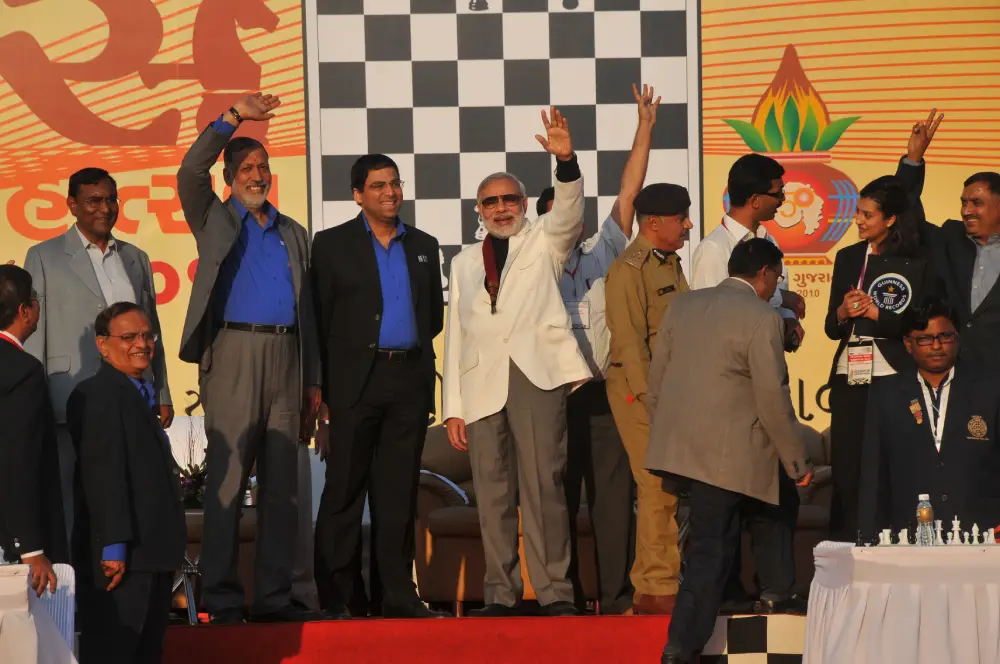 Men lighting ceremonial lamp at event with ITT banner in background