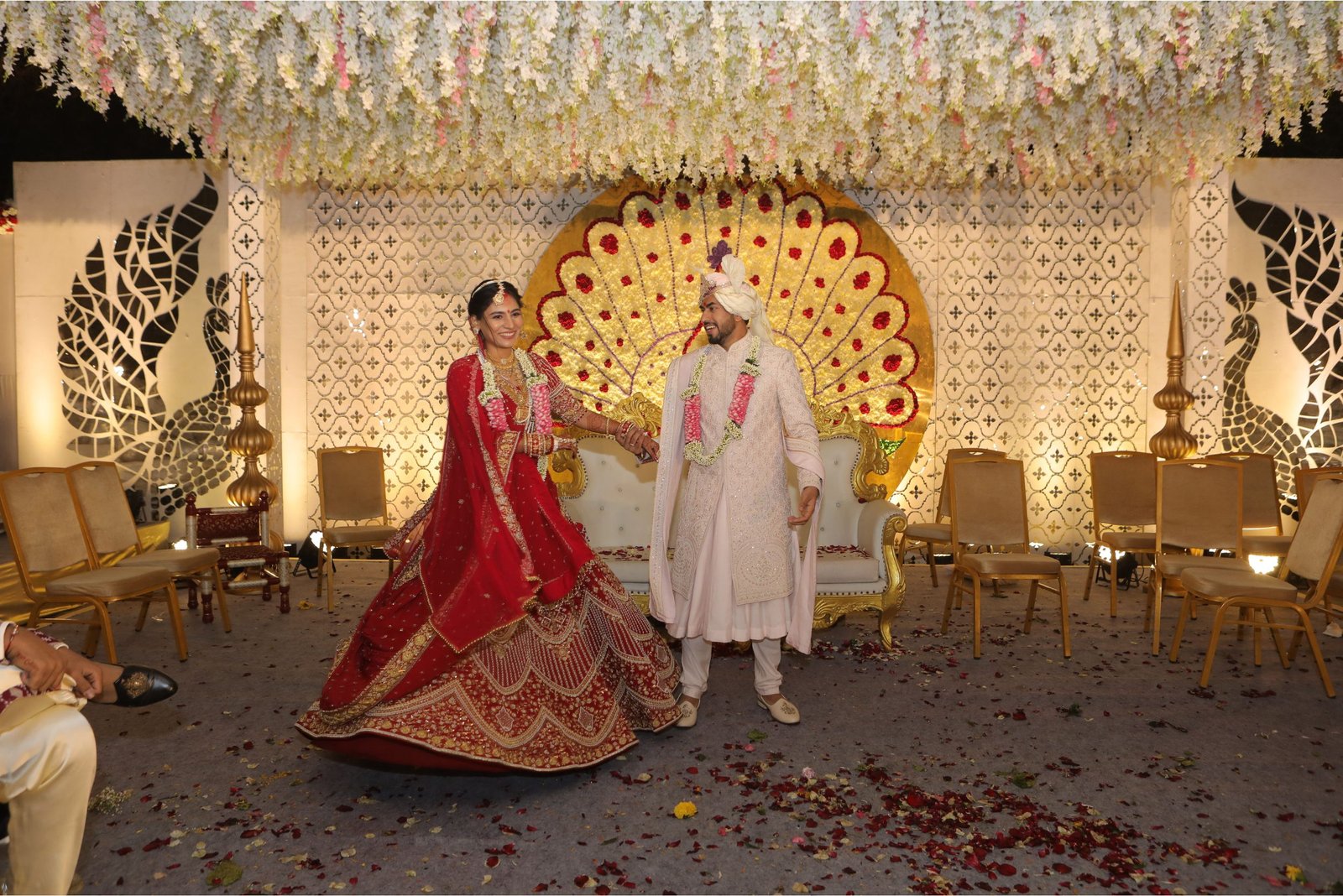 Men lighting ceremonial lamp at event with ITT banner in background