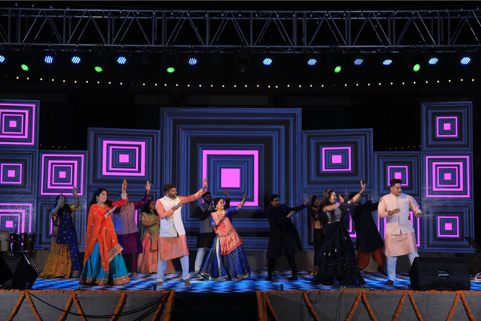 Men lighting ceremonial lamp at event with ITT banner in background