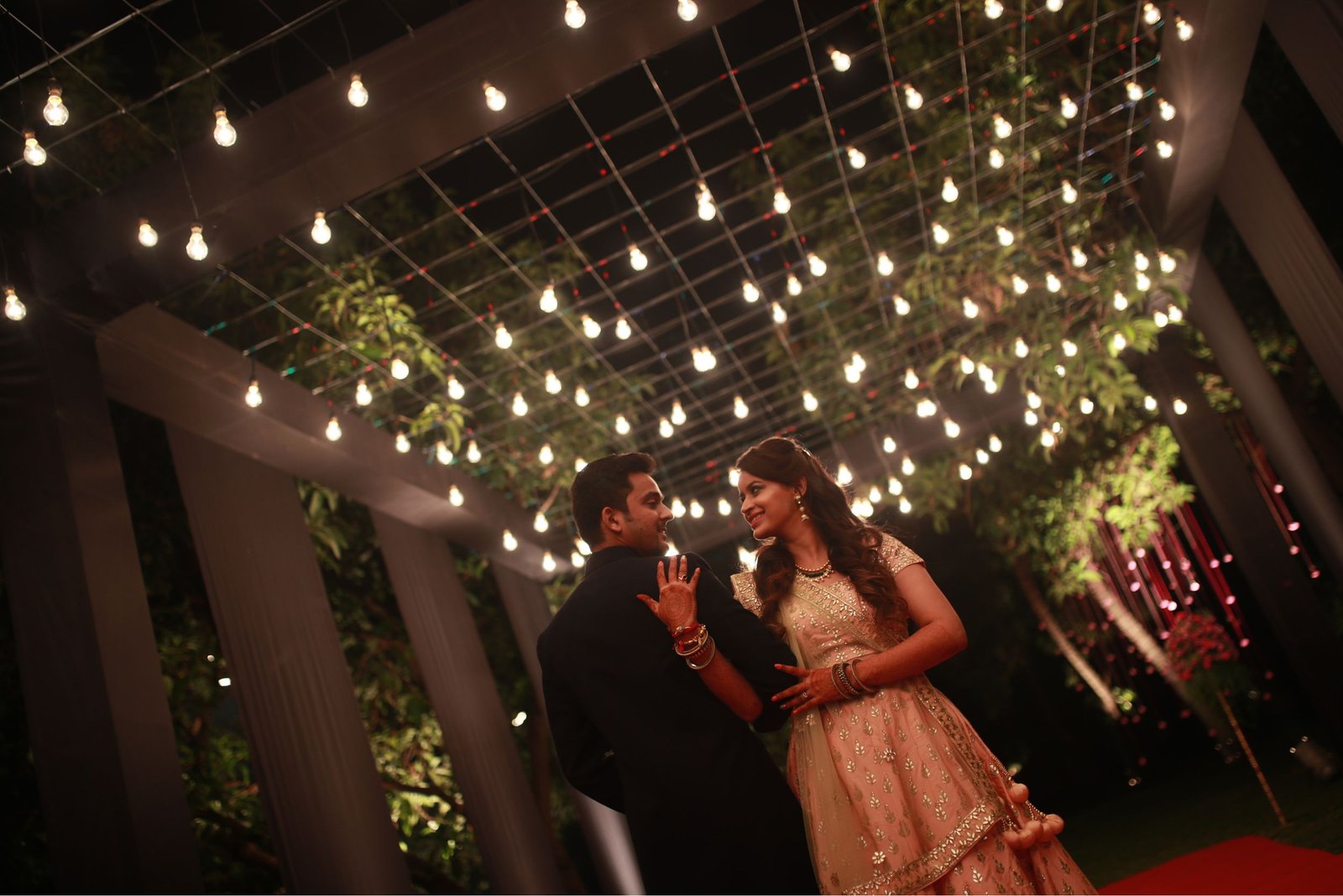 Men lighting ceremonial lamp at event with ITT banner in background