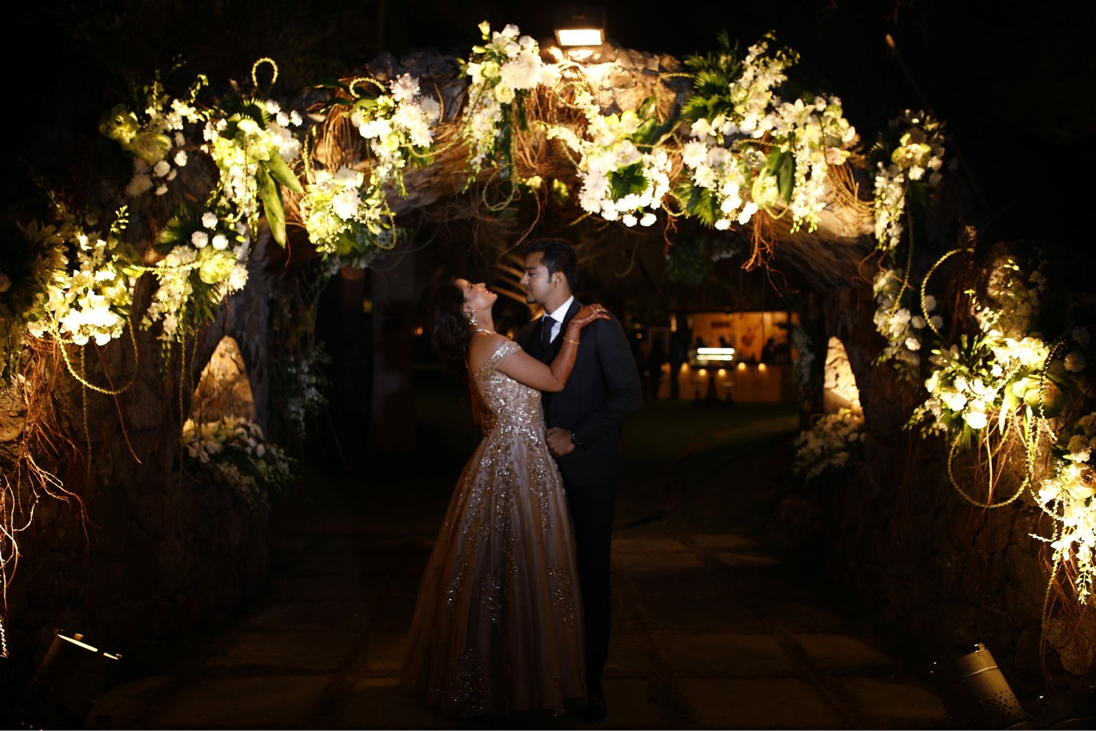 Men lighting ceremonial lamp at event with ITT banner in background