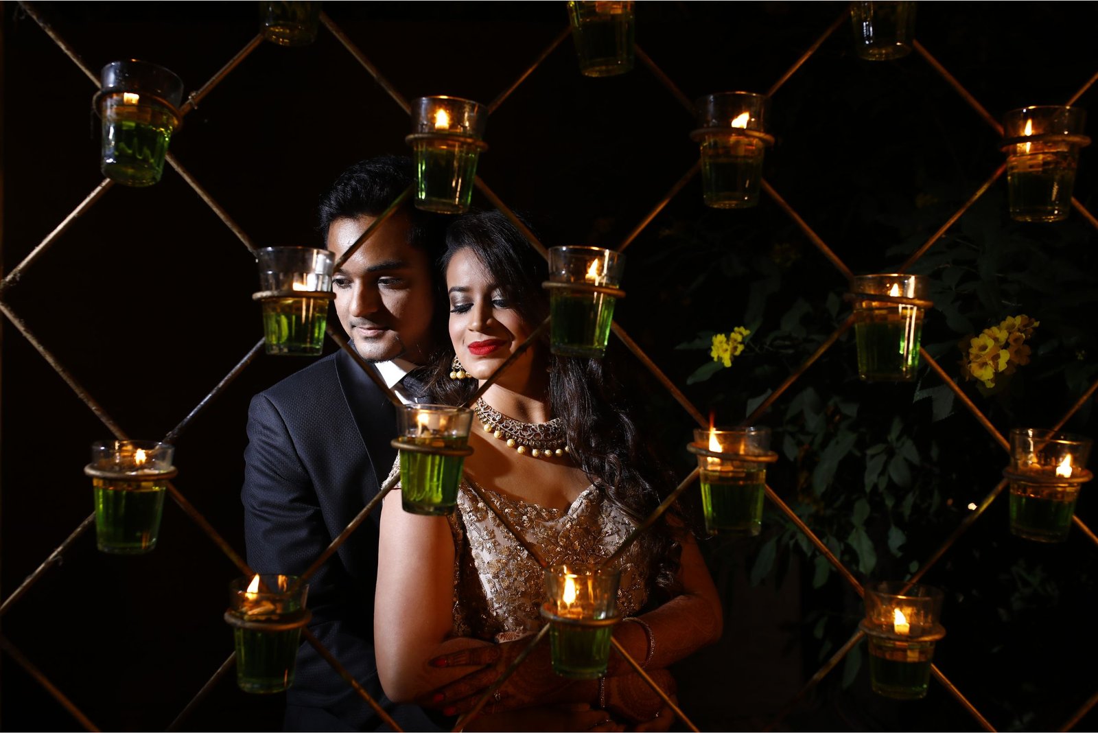Men lighting ceremonial lamp at event with ITT banner in background